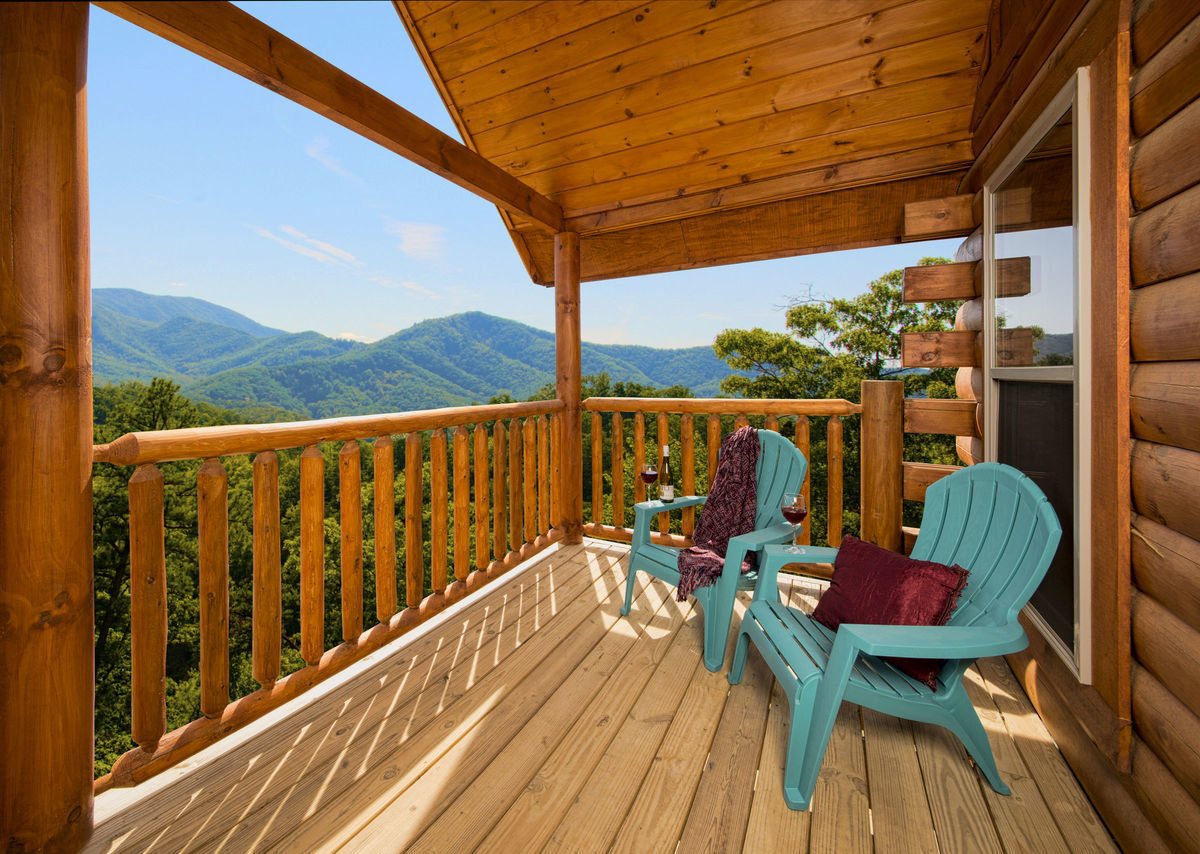 You can see miles of rolling mountains from this rustic balcony, a highlight of this Smoky Mountain cabin.